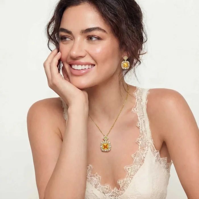 Golden Square Zirconia Necklace in gold-tone metal with a square amber-colored pendant and matching ornate drop earrings