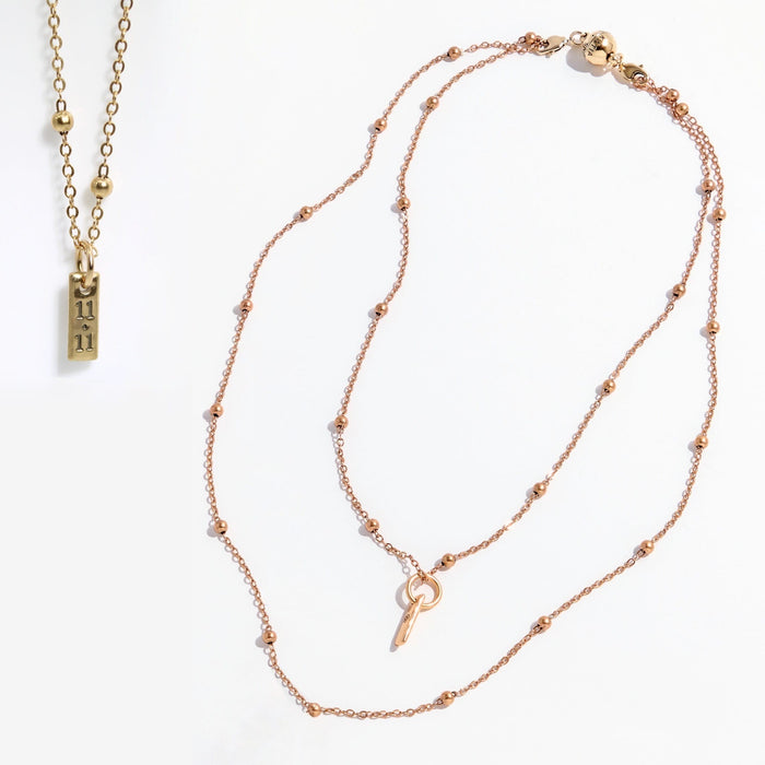 Two gold necklaces on a white background