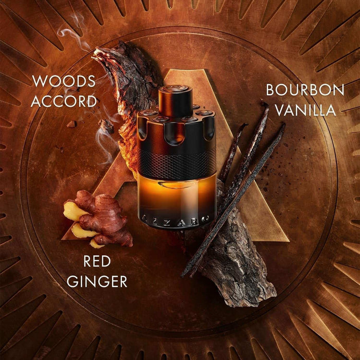 Azzaro The Most Wanted Parfum bottle in black and amber glass, featuring a textured black cap and red ginger, woods, and bourbon vanilla notes