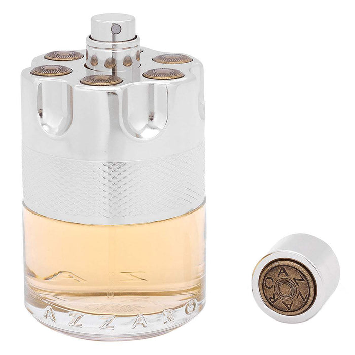 Azzaro Wanted Eau de Toilette in a clear glass bottle with pale amber liquid, silver textured cap and bronze accents