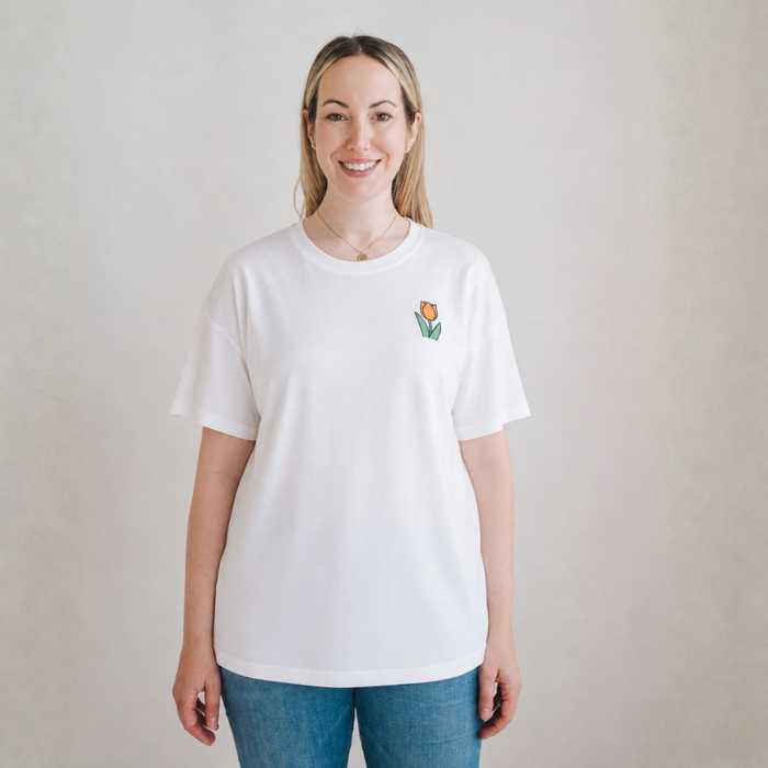 Woman wearing the Miffy white breastfeeding T-shirt with embroidered tulip and nursing zips