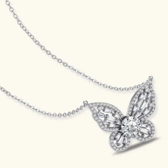Butterfly Moissanite Necklace in polished silver, with an openwork butterfly pendant, sparkling round center stone and baguette accents