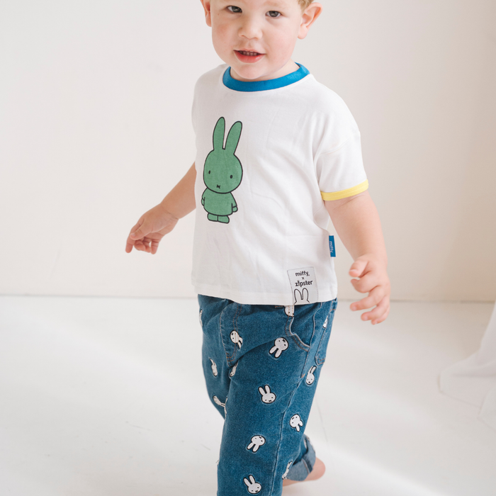 Child wearing the White Miffy children's T-shirt with green Miffy print