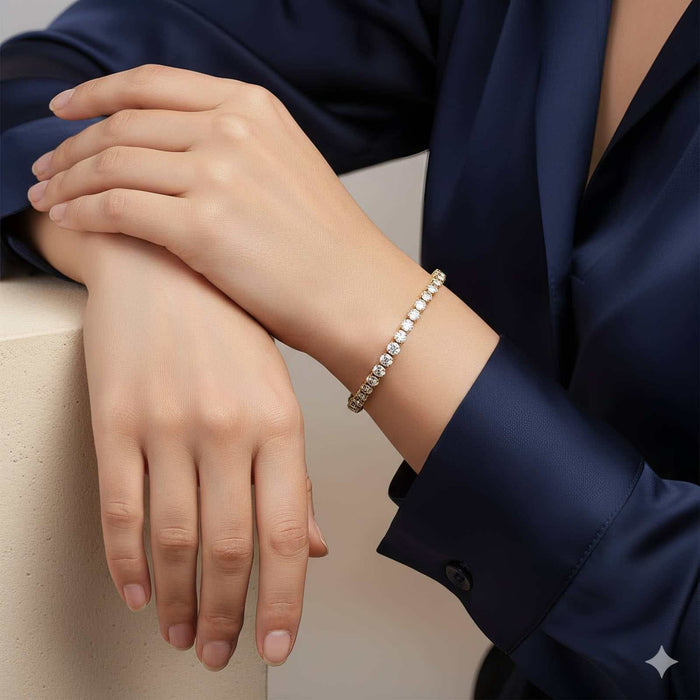 Cubic Zirconia Tennis Bracelet in gold-tone metal with a slim row of sparkling white stones and a delicate chain design