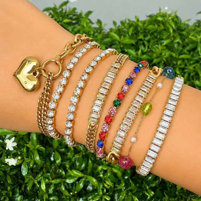 Cubic Zirconia Tennis Bracelet in gold-tone metal with rows of clear stones, shown among colorful stacked bracelets