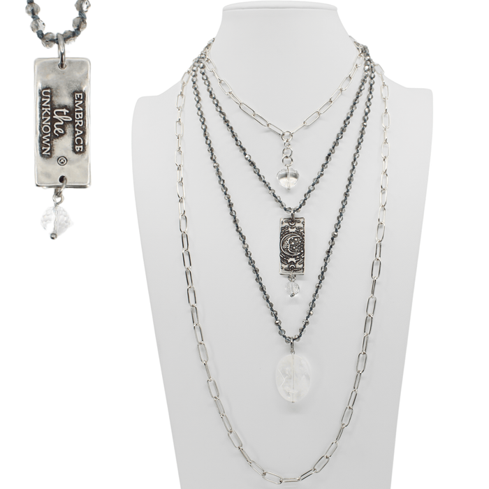 Multiple necklaces on a mannequin bust with visible brand name.