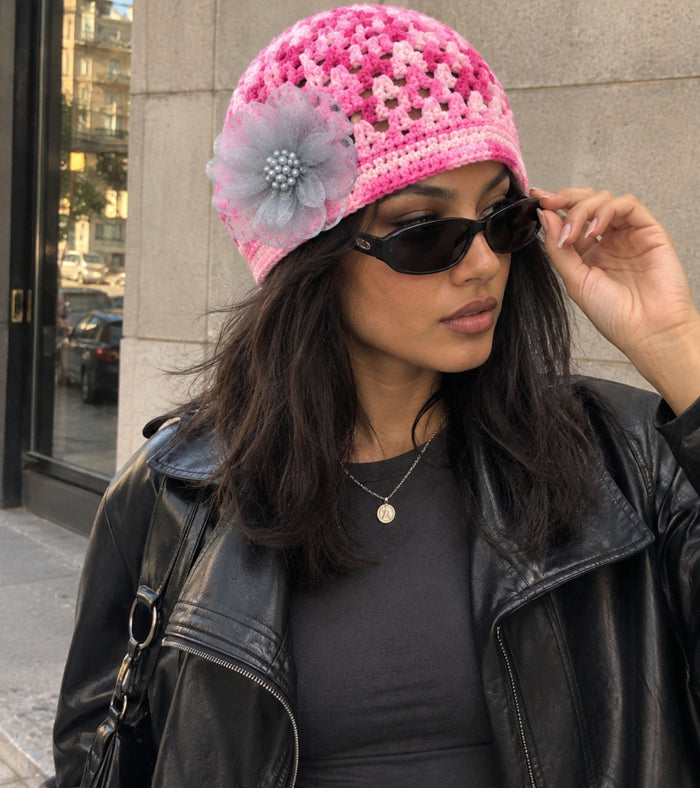 Pink knit beanie with crochet texture and gray tulle flower embellishment