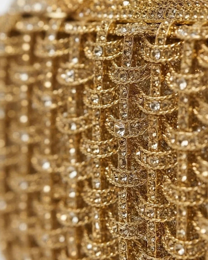 Close-up of gold rhinestone lattice on dog-shaped clutch