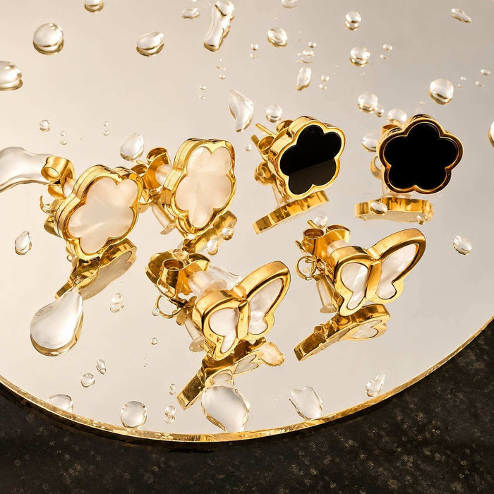 Flower Stud Earrings Style 1 feature gold-tone metal in glossy four-petal flower and butterfly shapes with black and cream inlays.