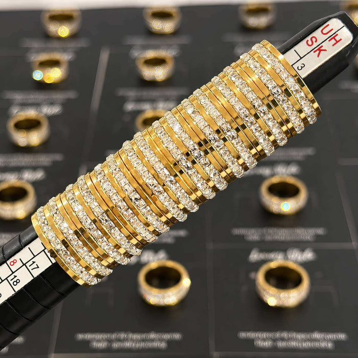 Gold Steel Cubic Zirconia Ring in gold-tone metal with rows of clear stones and a sparkling band design
