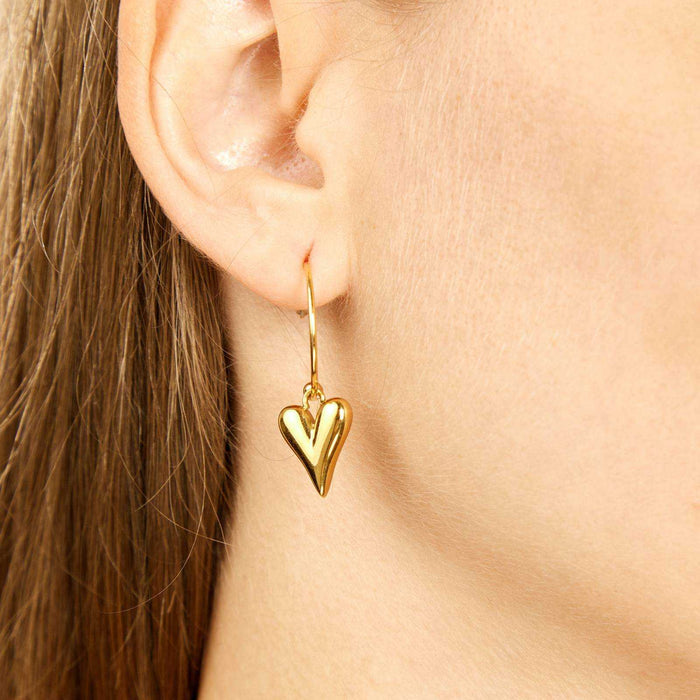 Heart Stud Earrings in polished gold-tone metal, shown as a dangling heart charm on a slender hook