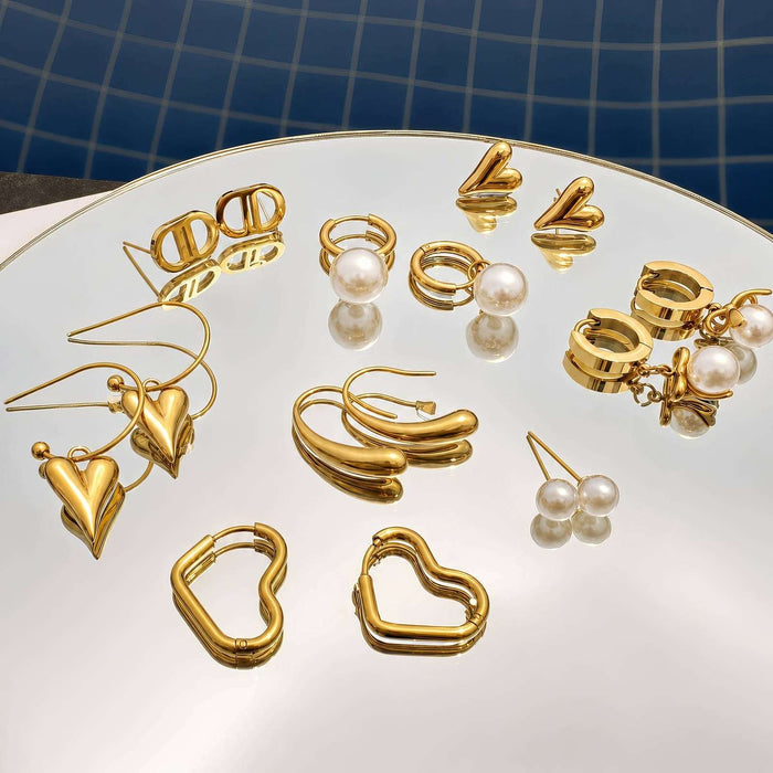 Heart Stud Earrings in polished gold-tone metal, featuring small sculpted heart shapes with a smooth finish