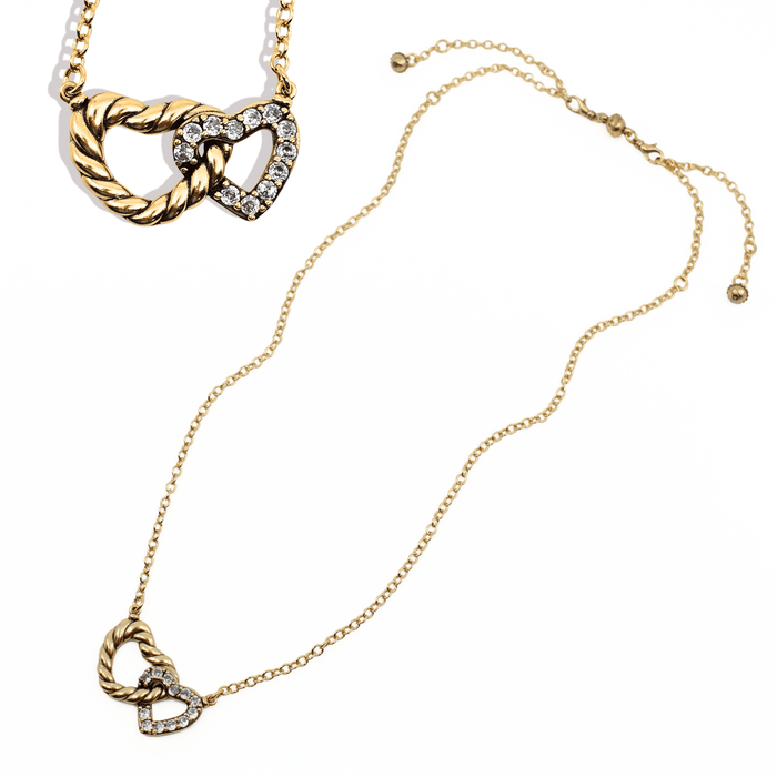 Gold necklace with heart-shaped pendant on a white background