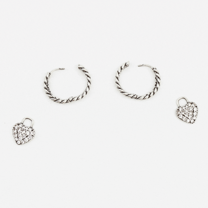 GIF of silver huggie hoops with pave heart charms