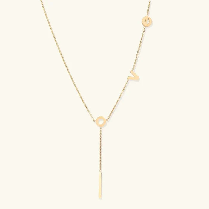 Love Letter Lariat Necklace in fine gold-tone chain with scattered letter charms, a circular connector and slim bar pendant