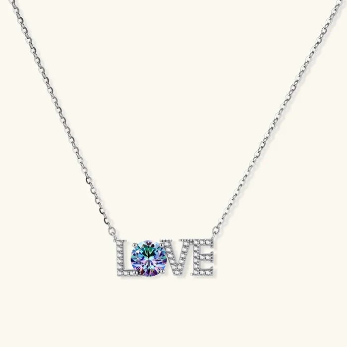 LOVE Moissanite Necklace in silver-toned metal, with pavé-set letters and a vivid round blue-violet center stone