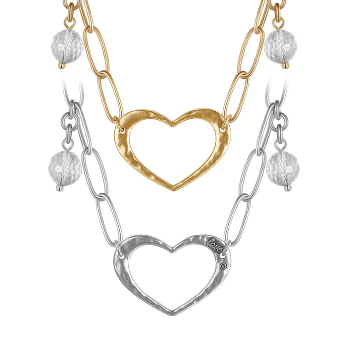 Two long chain necklaces with open heart pendants and crystal quartz accents, one with a gold-tone heart and clear quartz, and the other with a silver-tone heart and clear quartz.