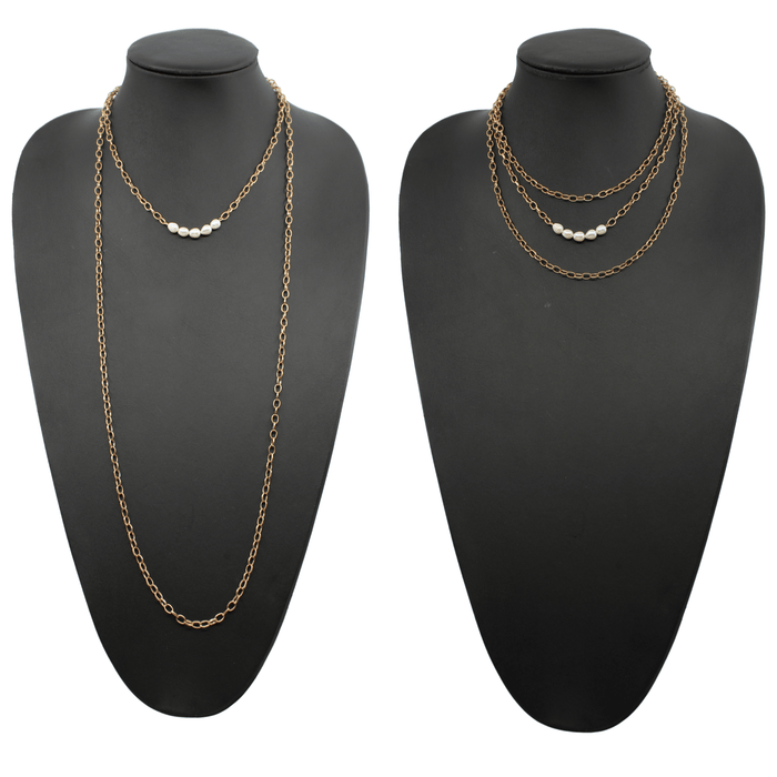 Two layering chain necklaces, one in gold finish and one in silver, each with pearl accent stones.