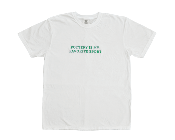 White crew neck t-shirt with the text 'Pottery Is My Favorite Sport' printed on the front.