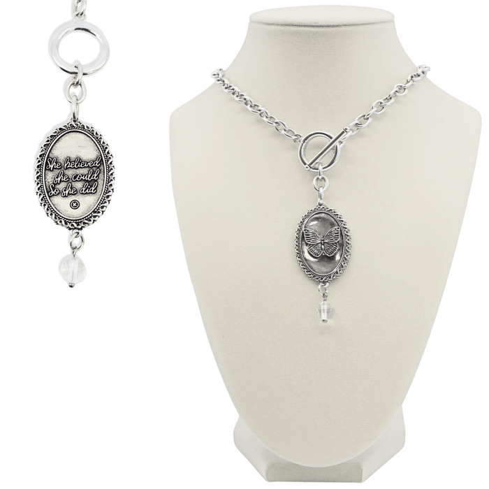 Silver necklace with pendant on a white mannequin bust
