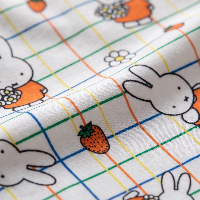 Close-up of the soft bamboo fabric of the ZIPSTER x Miffy Checkered Bloom bamboo babygrow