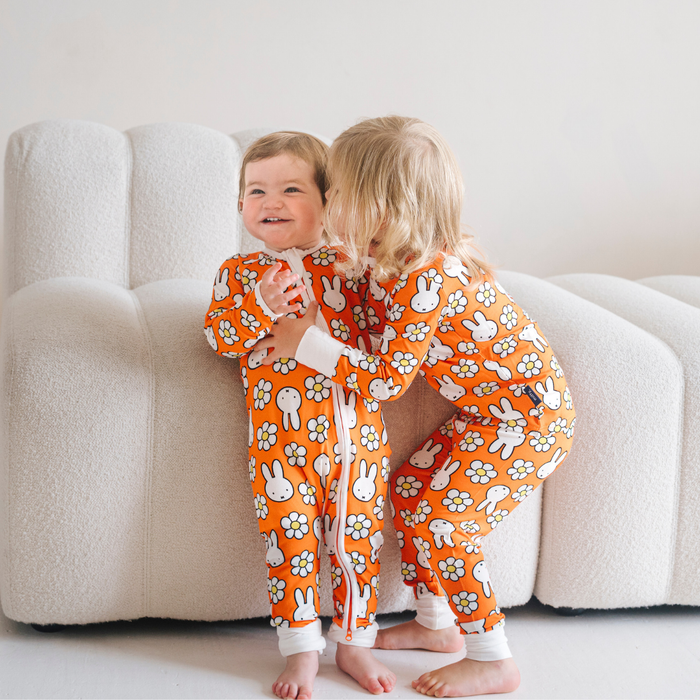 Baby wearing the ZIPSTER x Miffy Daisy Days bamboo babygrow