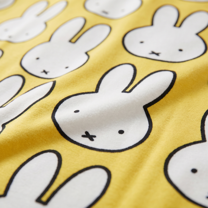 Close-up of the soft bamboo fabric of the ZIPSTER x Miffy Hello Yellow bamboo babygrow